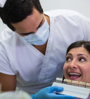dentist-examining-female-patient-with-teeth-shades_107420-74149