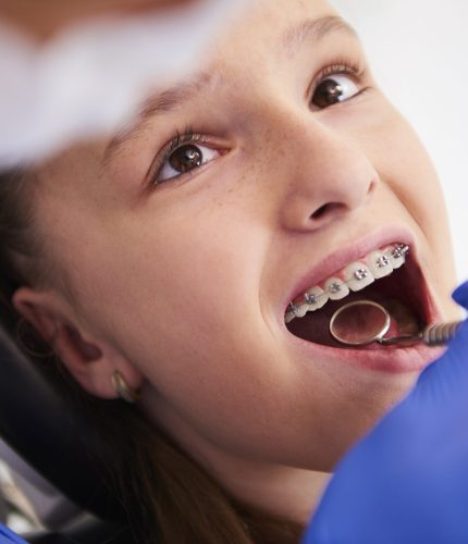 Girl with braces during a routine, dental examination
